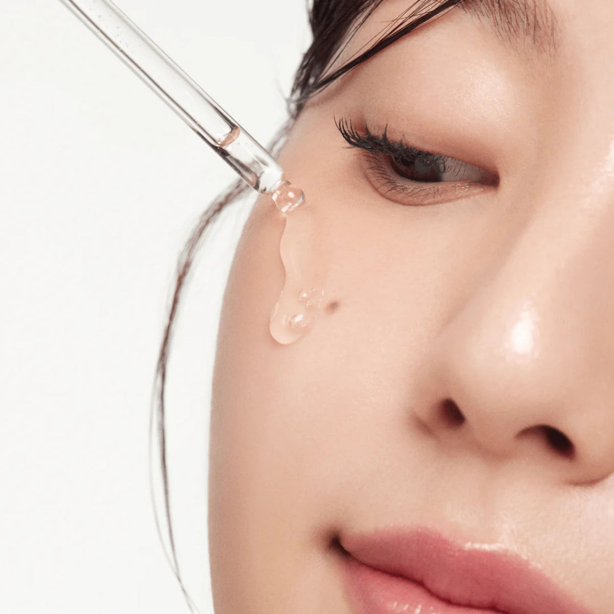 Applying Beauty of Joseon Glow Serum on face with dropper – lightweight Korean skincare serum for acne-prone, sensitive skin, providing hydration and glow.