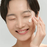 Model applying Beauty of Joseon Radiance Cleansing Balm on face – gentle oil cleanser that removes makeup, sunscreen, and impurities