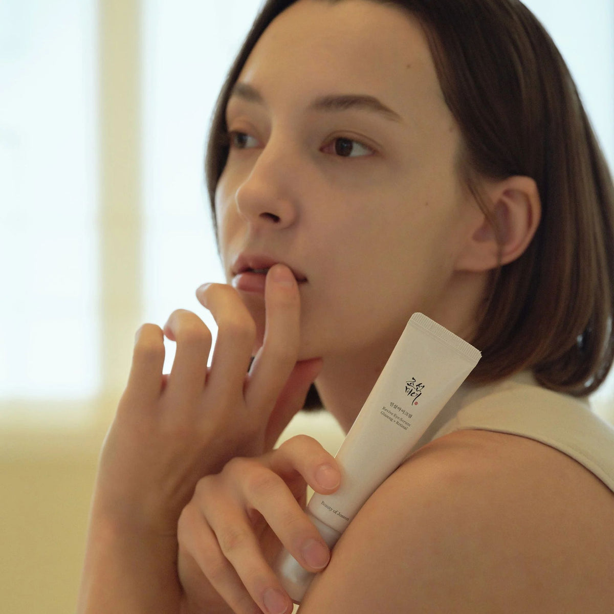 Model holding Beauty of Joseon Revive Eye Serum Ginseng + Retinal – gentle nourishing care for tired under-eyes