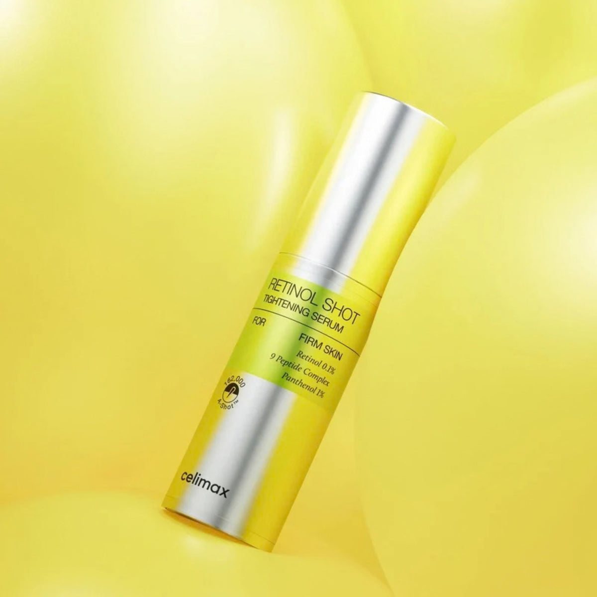 Celimax Retinol Shot Tightening Serum silver bottle on bright yellow background - Korean anti-aging retinol serum
