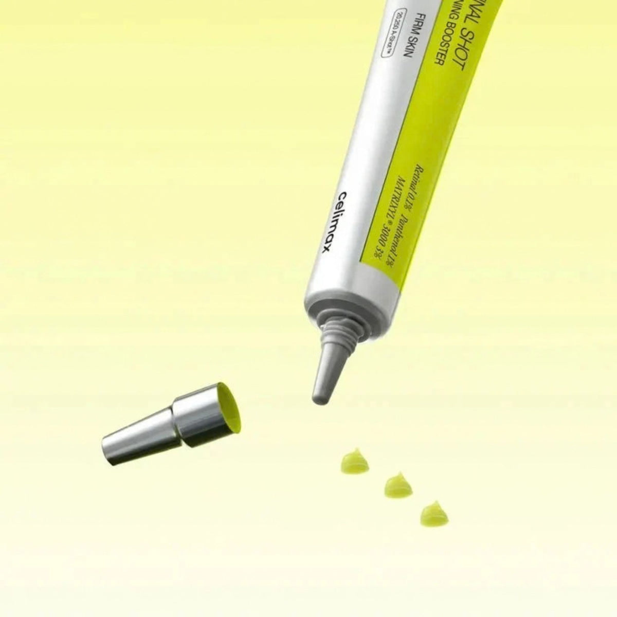 Celimax Retinal Shot Tightening Booster tube with cap off and small drops of lightweight retinal booster dispensing
