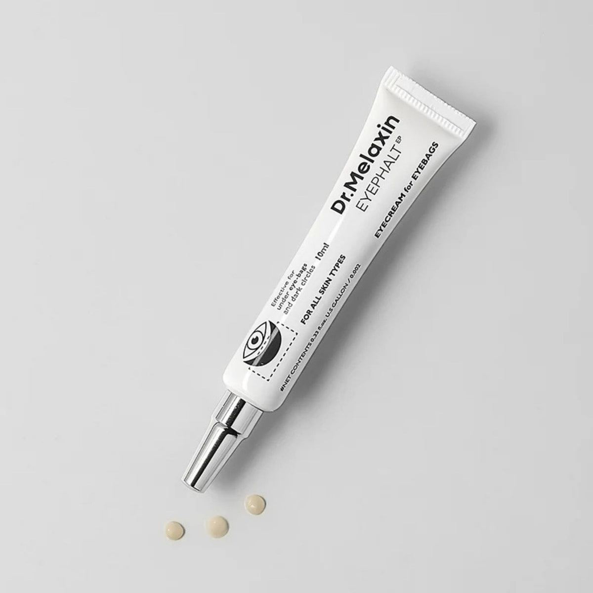 Dr.Melaxin Eyephalt Eye Cream with metal tip applicator and three dots of beige cream – under-eye bag treatment