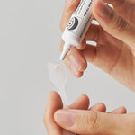 Dispensing Dr.Melaxin Eyephalt Eye Cream onto a spatula – small amount of eye bag cream for targeted under-eye application