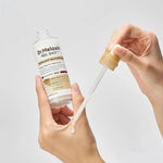 Applying Dr.Melaxin Peel Shot Rice Ampoule from the dropper onto the hand – milky exfoliating serum texture