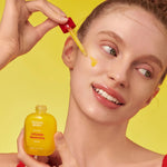 Model applying Eqqualberry Vitamin Illuminating Serum with dropper for brightening, glowing, even-toned skin