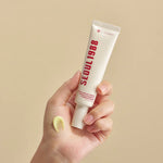 K-Secret Seoul 1988 Eye Cream – creamy yellow retinal formula shown on hand for firming and brightening under-eye skin