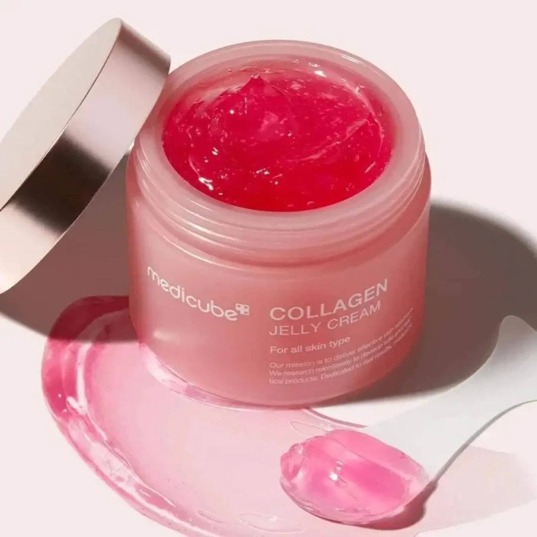 Medicube Collagen Jelly Cream open jar with glossy pink jelly cream texture and spatula