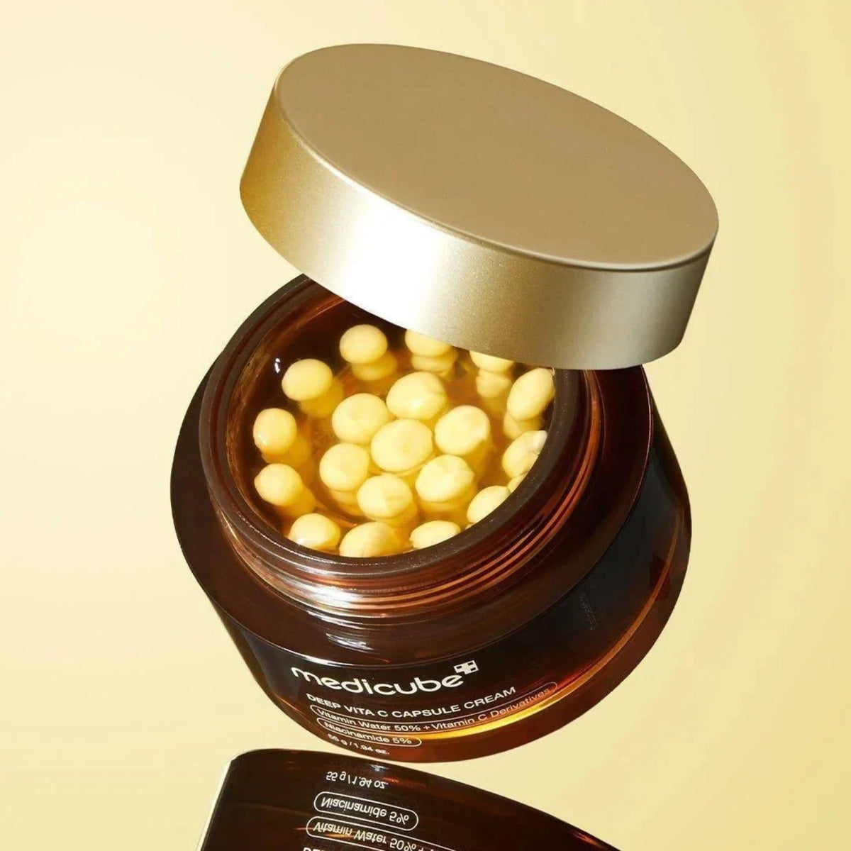 Medicube Deep Vita C Capsule Cream jar full of yellow vitamin capsules – brightening Korean cream for dull, uneven skin tone