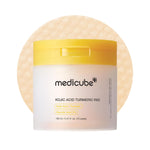 Medicube Kojic Acid Turmeric Pad 70 pads jar with Kojic Acid, Turmeric, and 3% Glycolic Acid on pad texture background