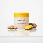 Medicube Kojic Acid Turmeric Pad jar surrounded by fresh turmeric root - brightening K-beauty toner pads