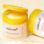 Open jar of Medicube Kojic Acid Turmeric Pad with 70 pre-soaked toner pads inside next to a second jar