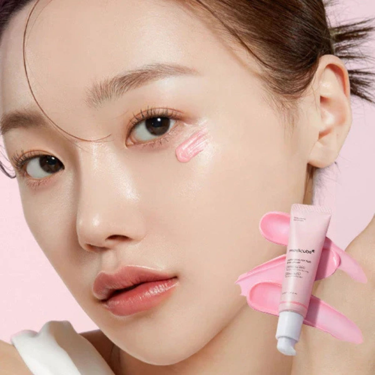 Woman applying Medicube PDRN Pink Peptide Eye Cream Korean skincare for dark circles and fine lines