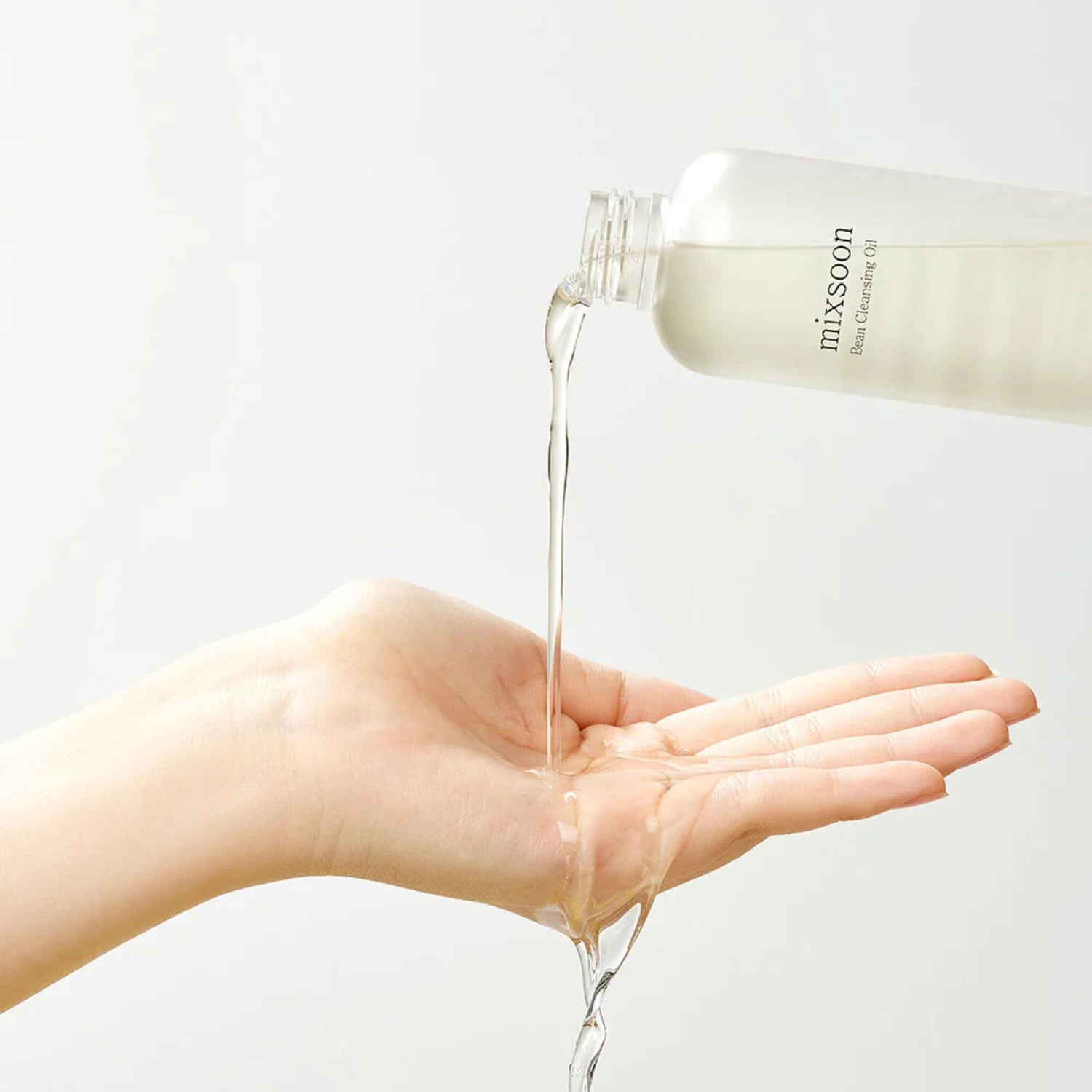Mixsoon Bean Cleansing Oil texture pouring onto hand – lightweight formula for pore cleansing and smooth skin