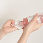 Applying Skin1004 Poremizing Clear Toner to cotton pad for pore care skincare routine