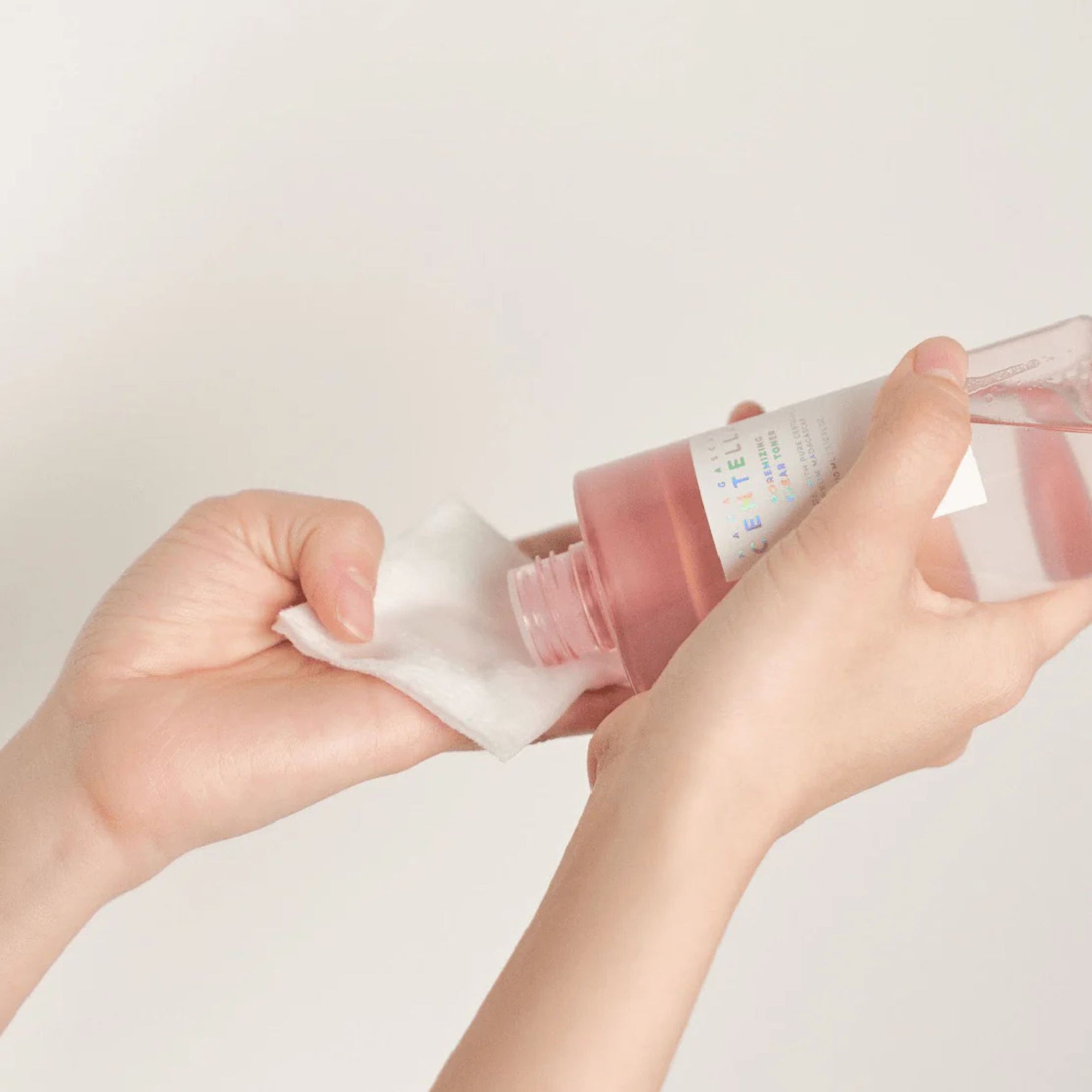 Applying Skin1004 Poremizing Clear Toner to cotton pad for pore care skincare routine