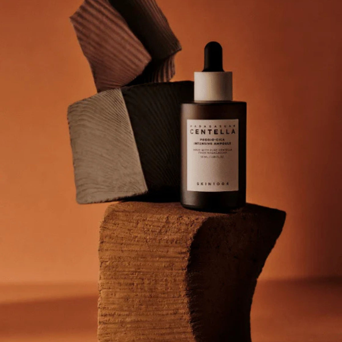 Skin1004 Madagascar Centella Probio-Cica Intensive Ampoule bottle on natural stone blocks – barrier-strengthening Korean skincare serum