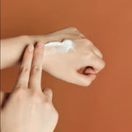 Applying Skin1004 Madagascar Centella Probio Cica Enrich Cream on hand to show nourishing texture and calming effect