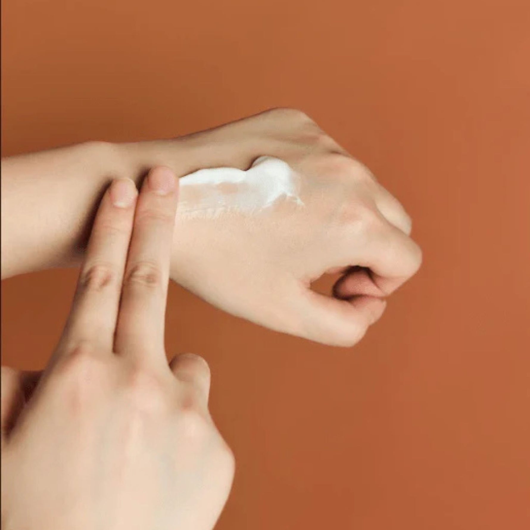 Applying Skin1004 Madagascar Centella Probio Cica Enrich Cream on hand to show nourishing texture and calming effect