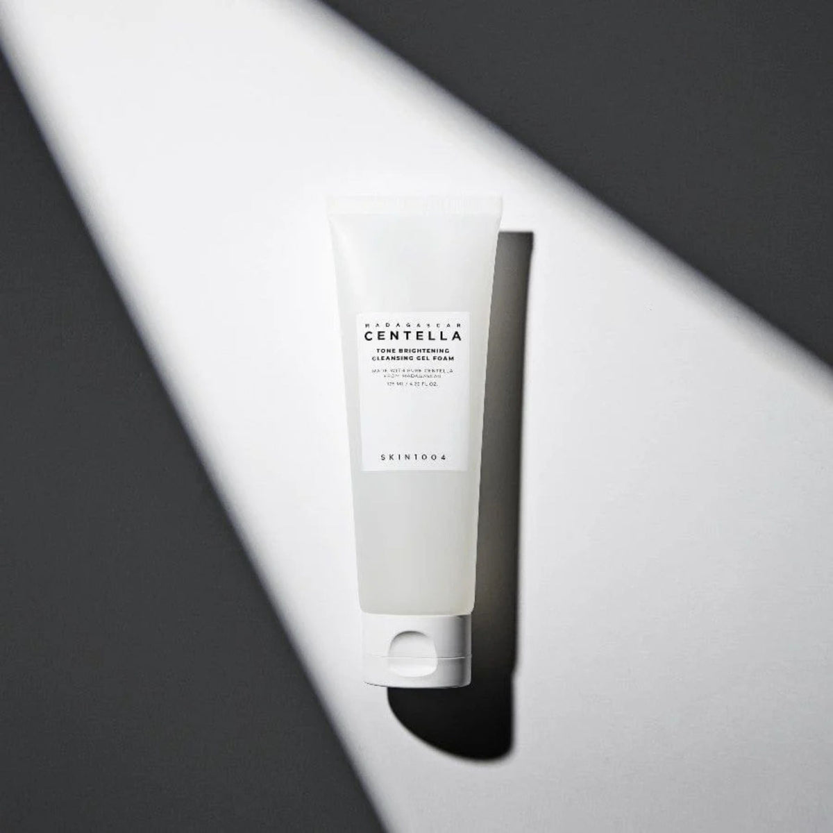 Skin1004 Madagascar Centella Tone Brightening Cleansing Gel Foam 125ml – brightening face cleanser with Centella Asiatica, Korean skincare product on minimal background