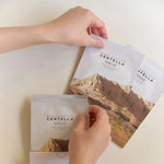 Hands holding Skin1004 Madagascar Centella Watergel Sheet Ampoule Mask pouches – lightweight hydrating mask for sensitive and irritated skin