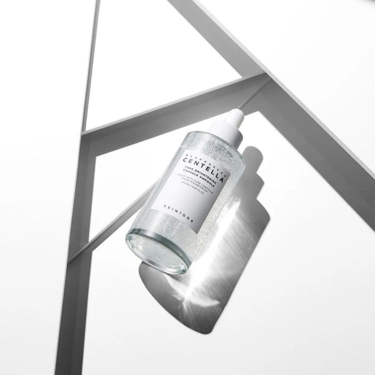 Skin1004 Tone Brightening Capsule Ampoule 100ml serum on white background with shadows showcasing brightening skincare