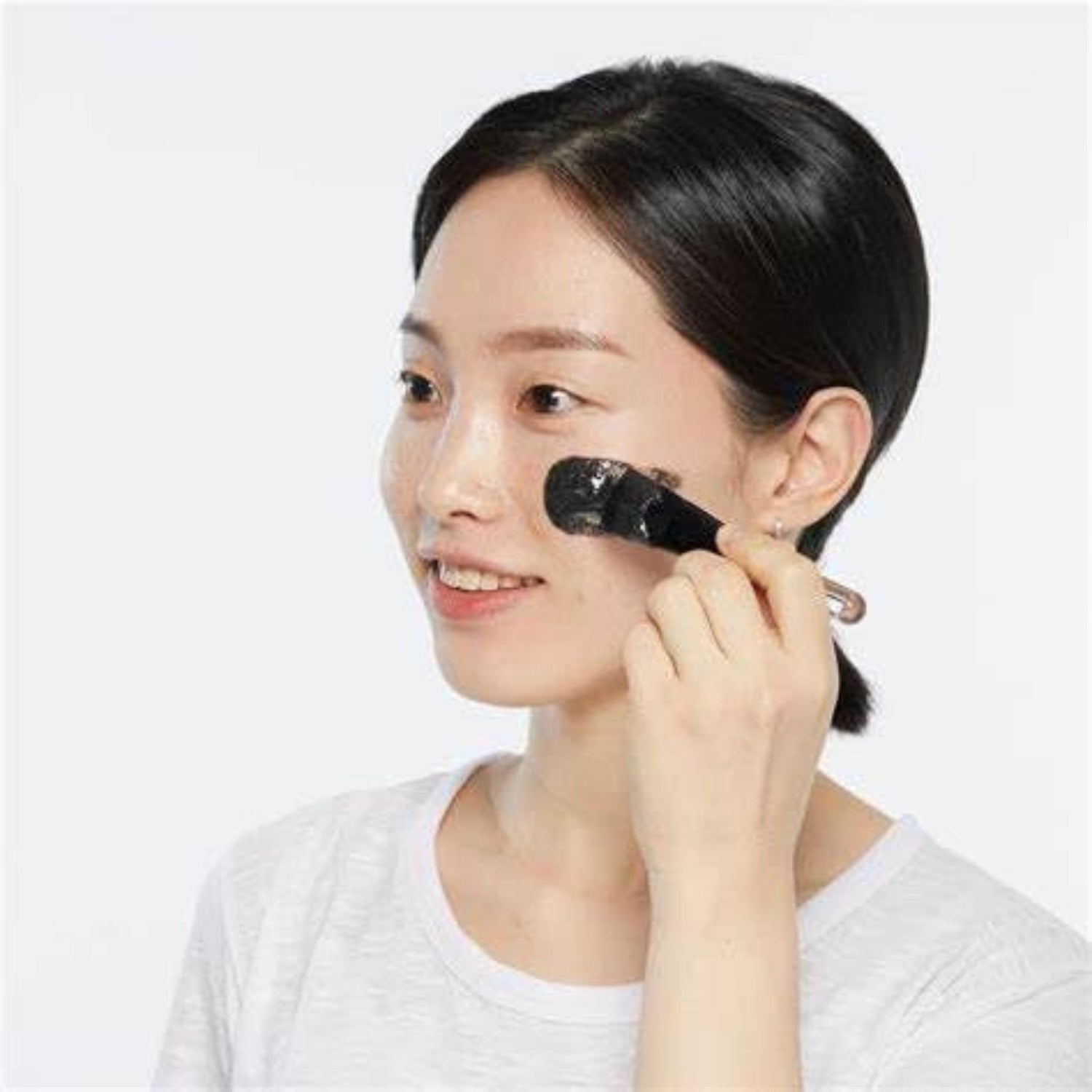 Model applying Skin1004 Zombie Pack and Activator Kit facial mask with brush – tightening and lifting treatment for smoother, youthful-looking skin.